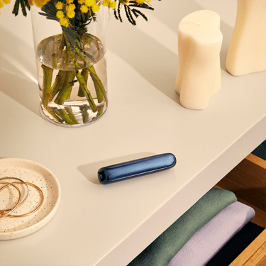 Ploom AURA front panel Navy Blue Augmented Pattern accessory on device, located on a table
