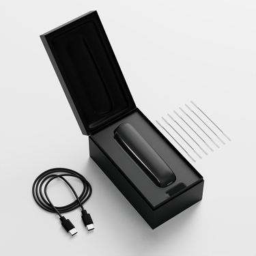 Ploom AURA open box showing the device, its charging cable and cleaning sticks
