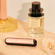 Ploom AURA front panels with Rose Gold Augmented Pattern placed on a dressing table
