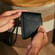 Hand holding a Ploom Duo Carry Case Jet Black accessory
