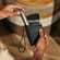 Hand taking a Ploom AURA device out of the Ploom Duo Carry Case Jet Black