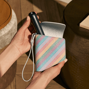 Ruka vadi Ploom AURA uređaj iz Ploom Multicolored Patterned Canvas Duo futrole